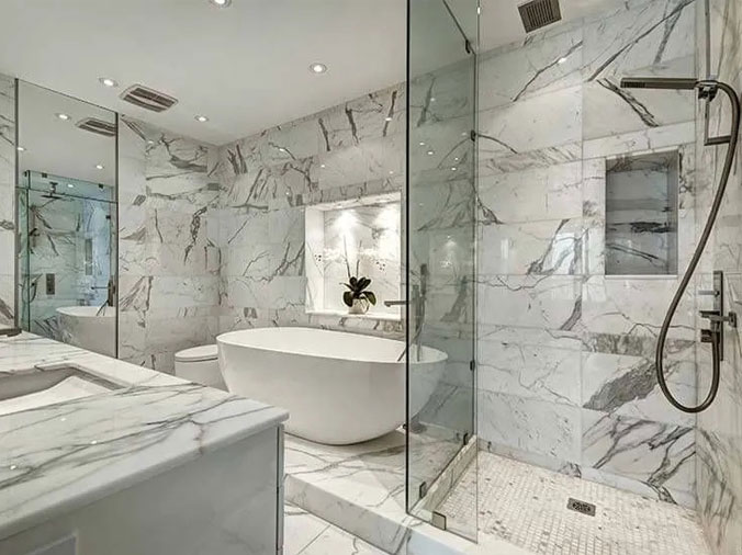 Bathroom with free shanding bathrub abd marble walls & counters