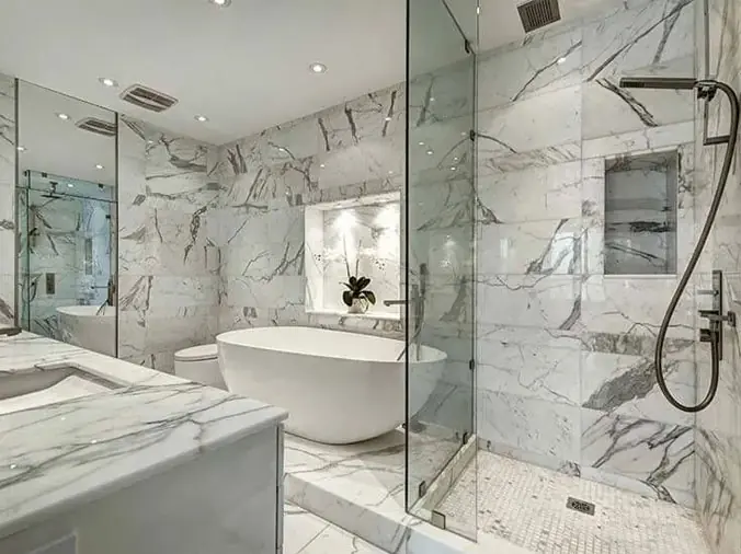 Bathroom with free shanding bathrub abd marble walls & counters