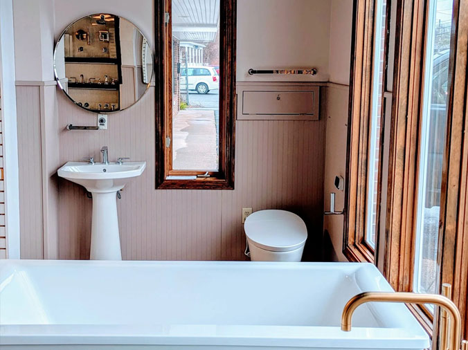 Bathroom with wood trim and brished bronze faucets