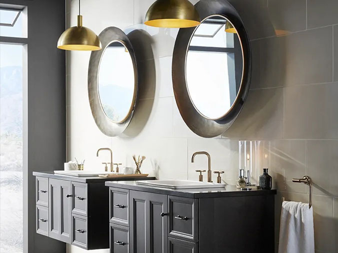 Bathroom with dual vanities and sinks with brushed bronze faucets and fixtures