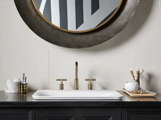 Bathroom sink with brushed bronze faucet and fixtures