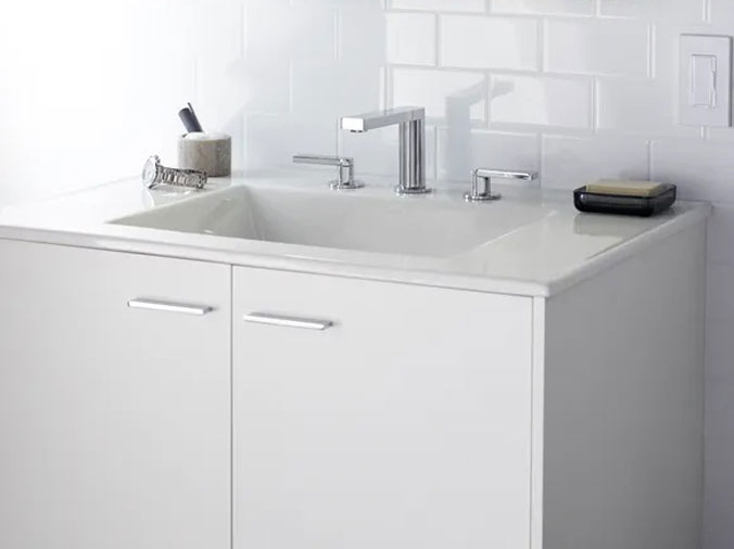 White bathroom vanicy with silver faucet
