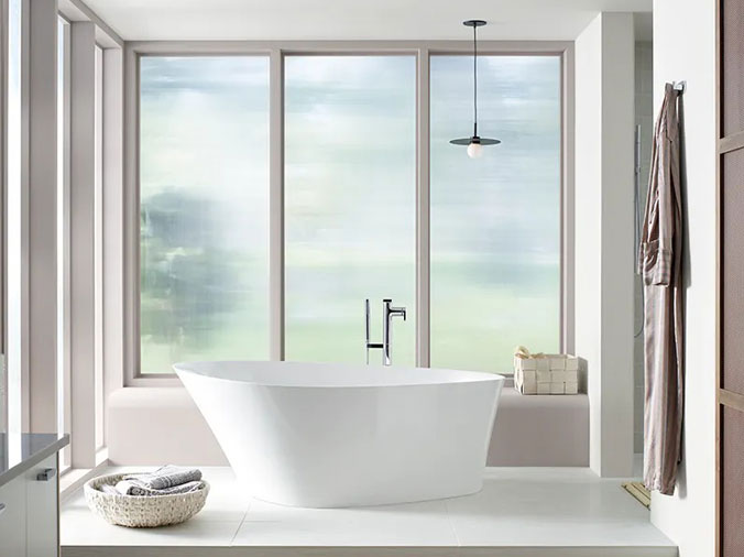 Free standing bathtub with frosted windows behind