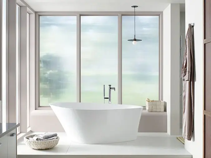 Free standing bathtub with frosted windows behind