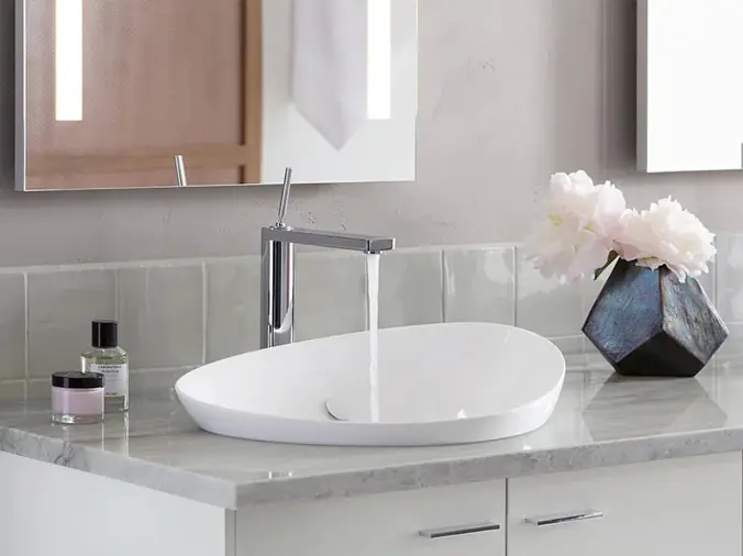 Bathroom basin sink with silver running faucet