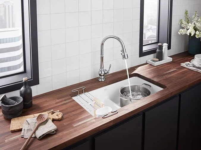 Kitchen sink with dark wood countertop