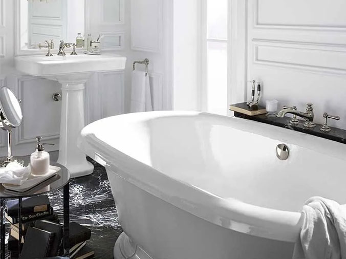 Feww standing bathtub with pedistal sink in the background