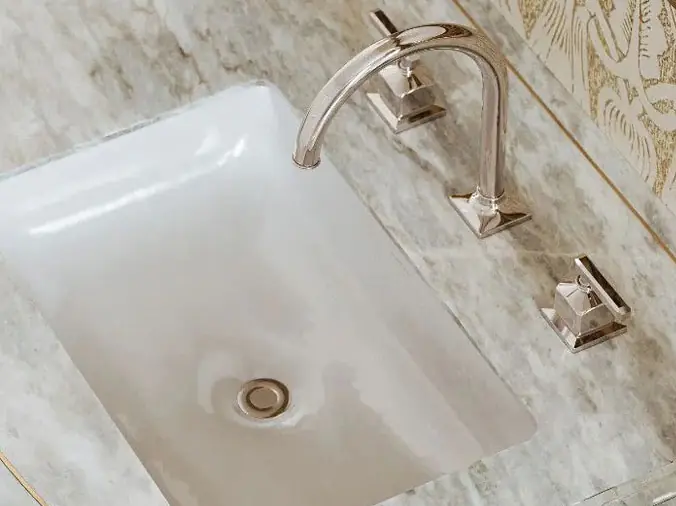 Bathroom sink with bright brass faucet