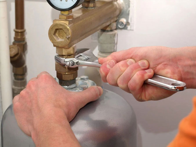 Closeup of plumber tightening a fitting